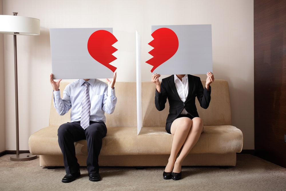 Couple Holding a picture of broken heart