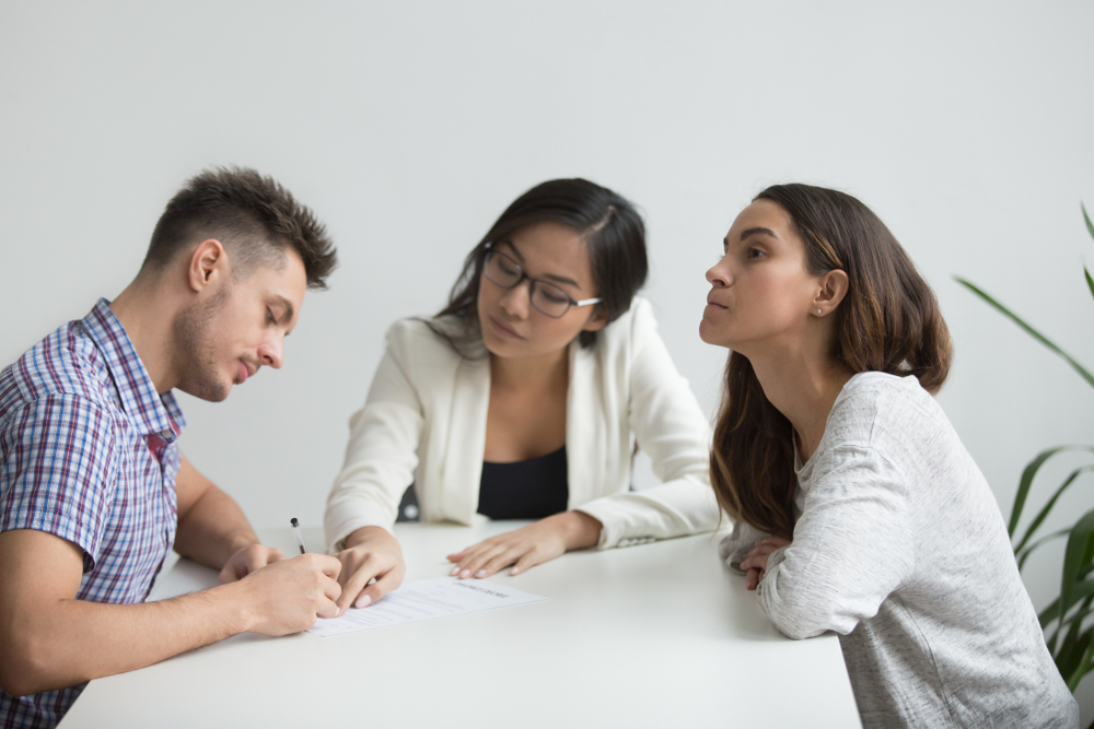 Couple signing divorce papers
