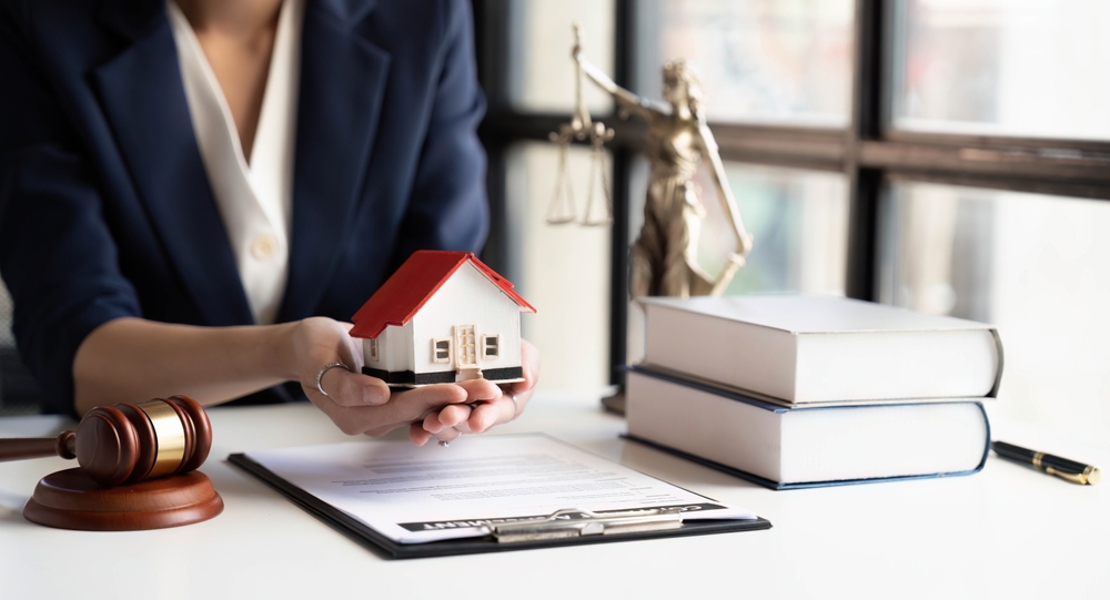 Person holding toy house in hands